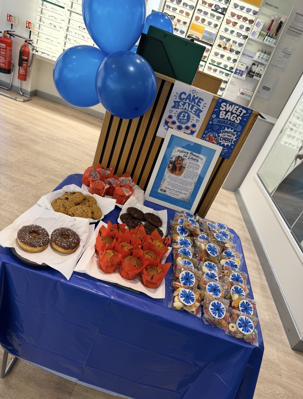 Cakes and fundraising information on a table at Specsavers Mansfield